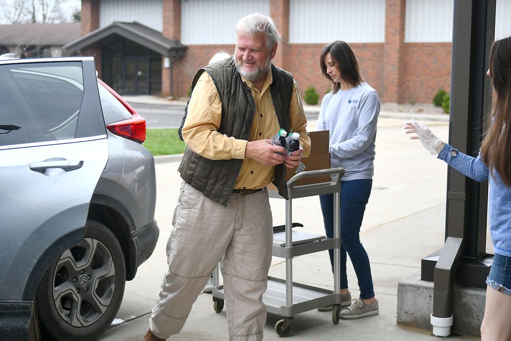 Jim Abernathy, left, picks up communion